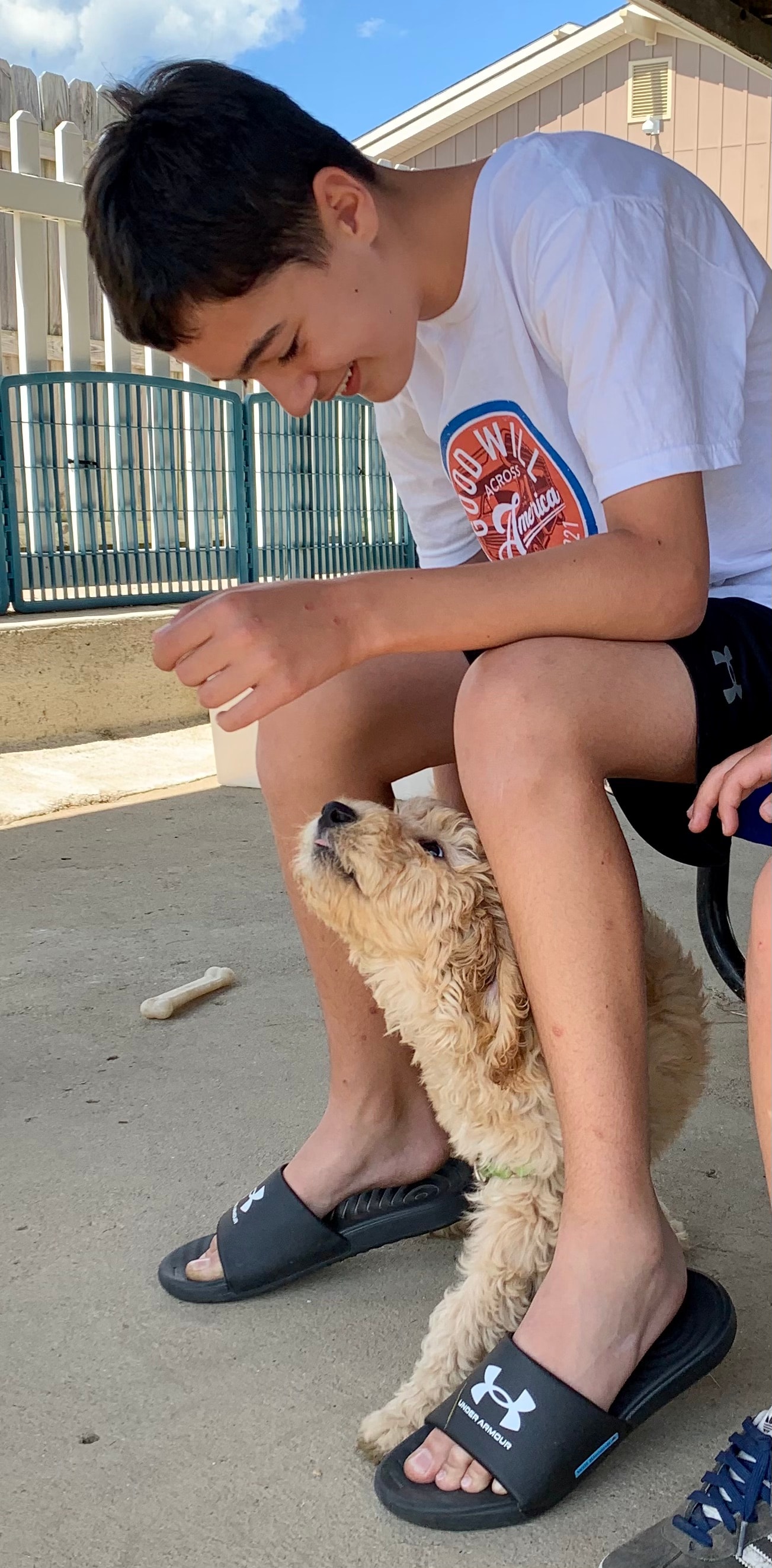 Will smiling with a puppy at 4 Paws For Ability